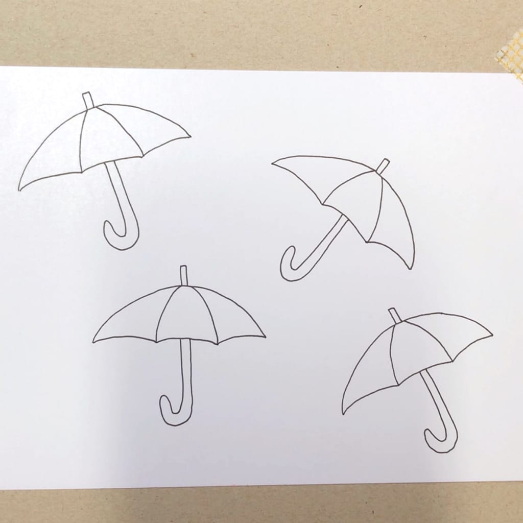 Step 1: Draw a couple of simple umbrellas