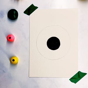 Step 2: Find a larger circular object and trace it around the black circle to create the iris.