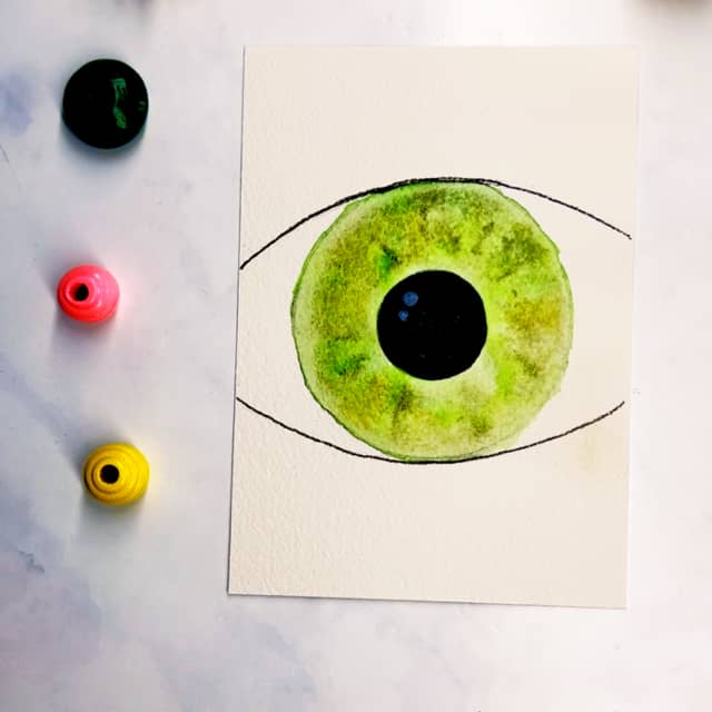Step 6: Once the paint is dry, add some white specks to the black pupil.