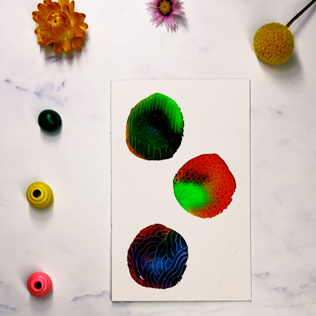 Step 4: Using your white gel pen or paint marker, decorate your dried circles with patterns