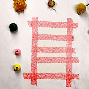 Step 1: Start by applying horizontal strips of tape across your page, leaving small gaps in between.