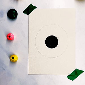Step 2: Find a larger circular object and trace it around the black circle to create the iris.